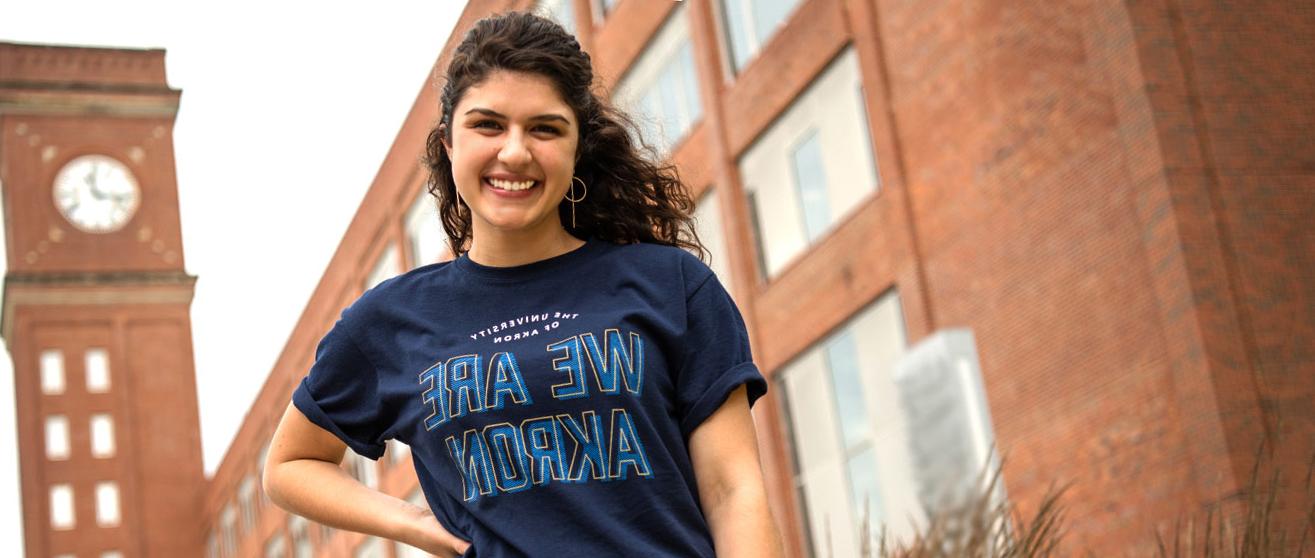 Student smiling on campus at the University of Akron